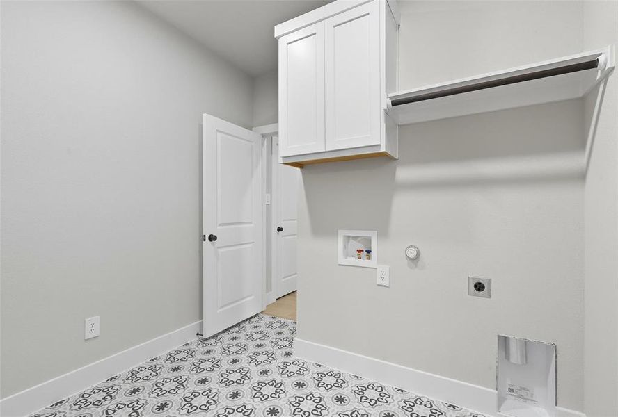 Laundry area with gas dryer hookup, cabinet space, hookup for an electric dryer, and hookup for a washing machine Laundry area with gas dryer hookup, cabinet space, hookup for an electric dryer, and hookup for a washing machine