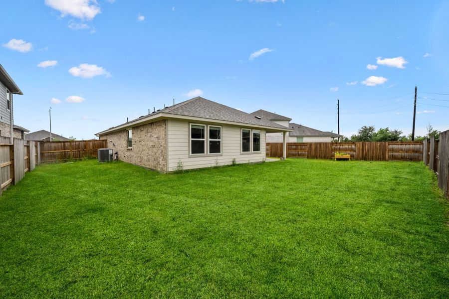 Exterior details and patio area of a home in Heights of Barbers Hill, Mont Belvieu (Image 4).