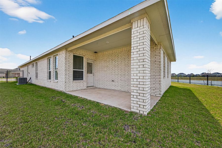 Exterior details and patio area of a home in Sunterra, Katy (Image 31).