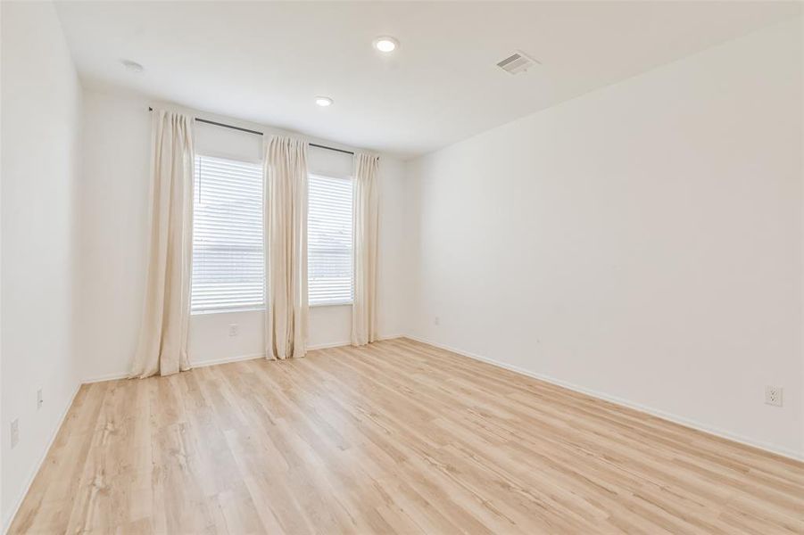 Restful primary sanctuary with a cozy bedroom, an en-suite bathroom and an upgraded *California Closets* walk-in closet.