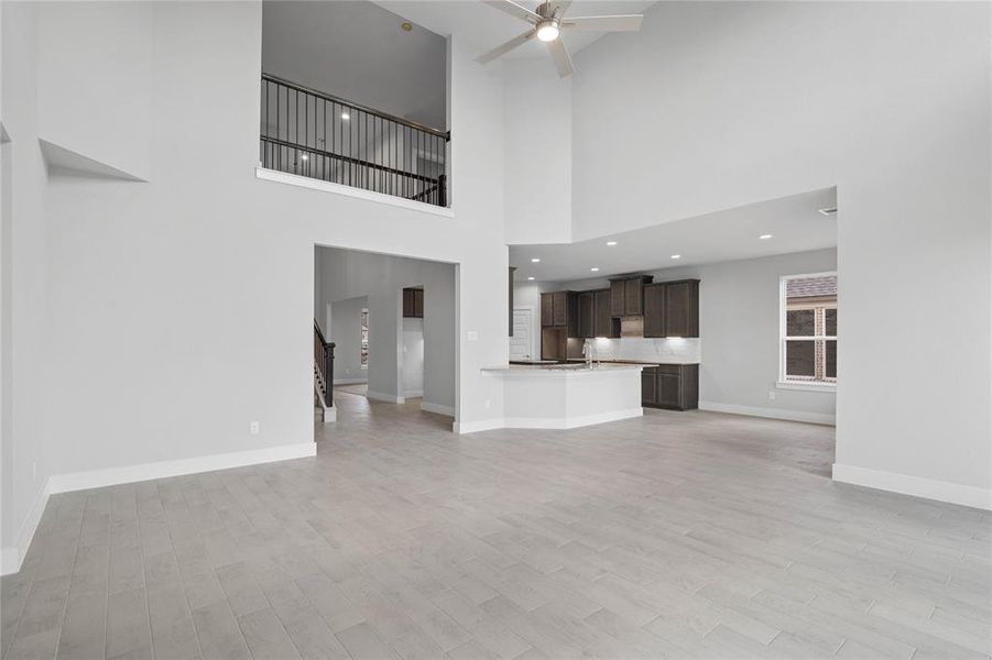 Another view from the Family Room looking into the breakfast nook and kitchen areas; as well as the upstairs Loft/Game Room.