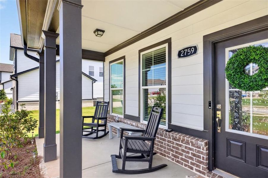 Exterior details and patio area of a home in Porches at Mobley Lake, Dacula (Image 23).
