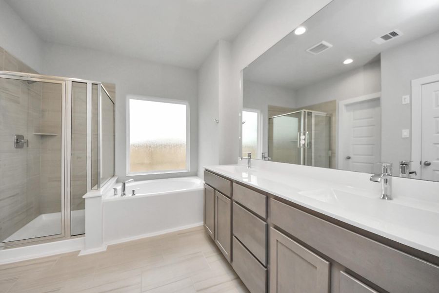 Indulge in a spa-like retreat within the confines of this primary bathroom.Delight in a spacious walk-in shower enveloped in stylish tile surround, and unwindin a separate garden tub adorned with custom detailing. Sample photo of completed home with similar floor plan. Actual colors and selections may vary. Indulge in a spa-like retreat within the confines of this primary bathroom.Delight in a spacious walk-in shower enveloped in stylish tile surround, and unwindin a separate garden tub adorned with custom detailing. Sample photo of completed home with similar floor plan. Actual colors and selections may vary.