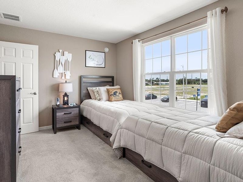 Large secondary bedrooms provide space for everyone in your household - Isla townhome by Highland Homes