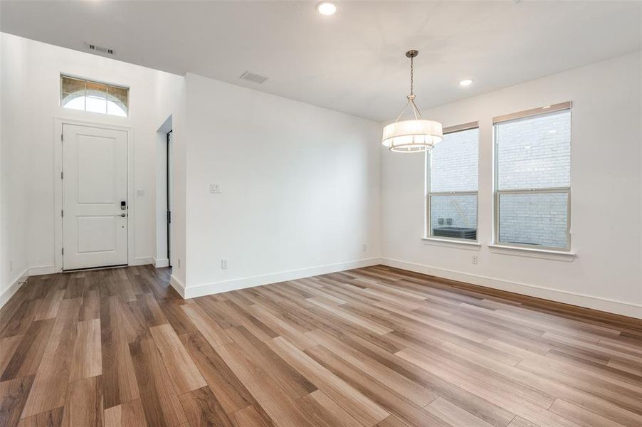 Unfurnished dining area featuring recessed lighting and light wood-style flooring Unfurnished dining area featuring recessed lighting and light wood-style flooring