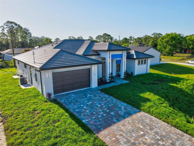 Front exterior of a new home in , Lehigh Acres, FL, highlighting curb appeal (Image 1).