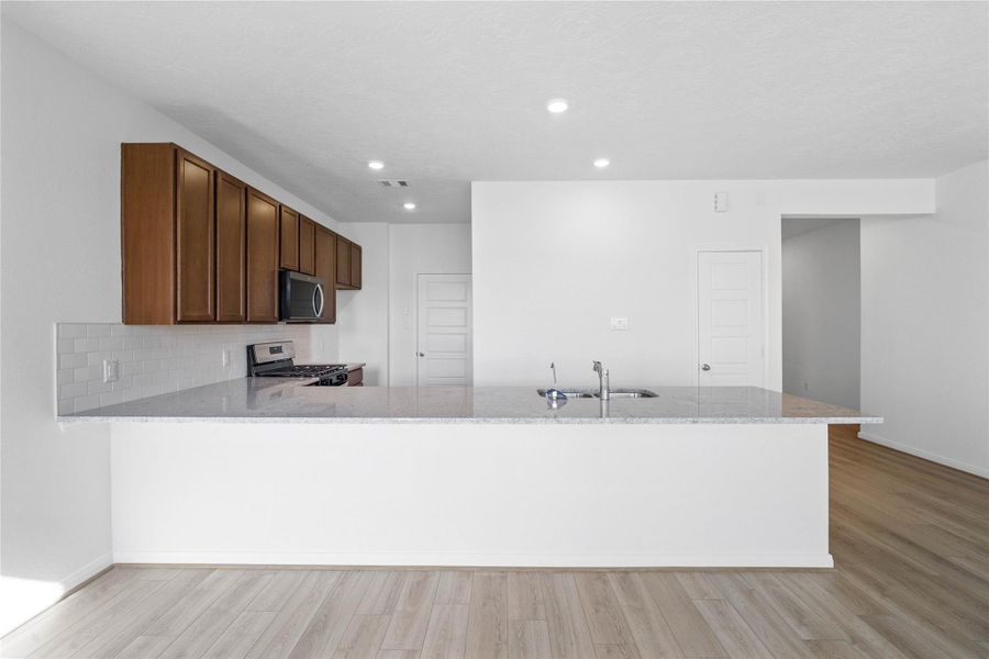 This spacious kitchen has it all—ample storage, generous counter space, and a layout that truly makes it the heart of the home.
