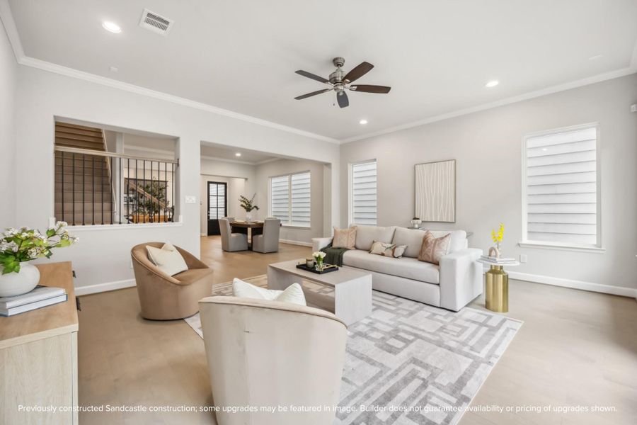 Bright and inviting, with a ceiling fan and recessed lights, the living room is the perfect spot for any activity.