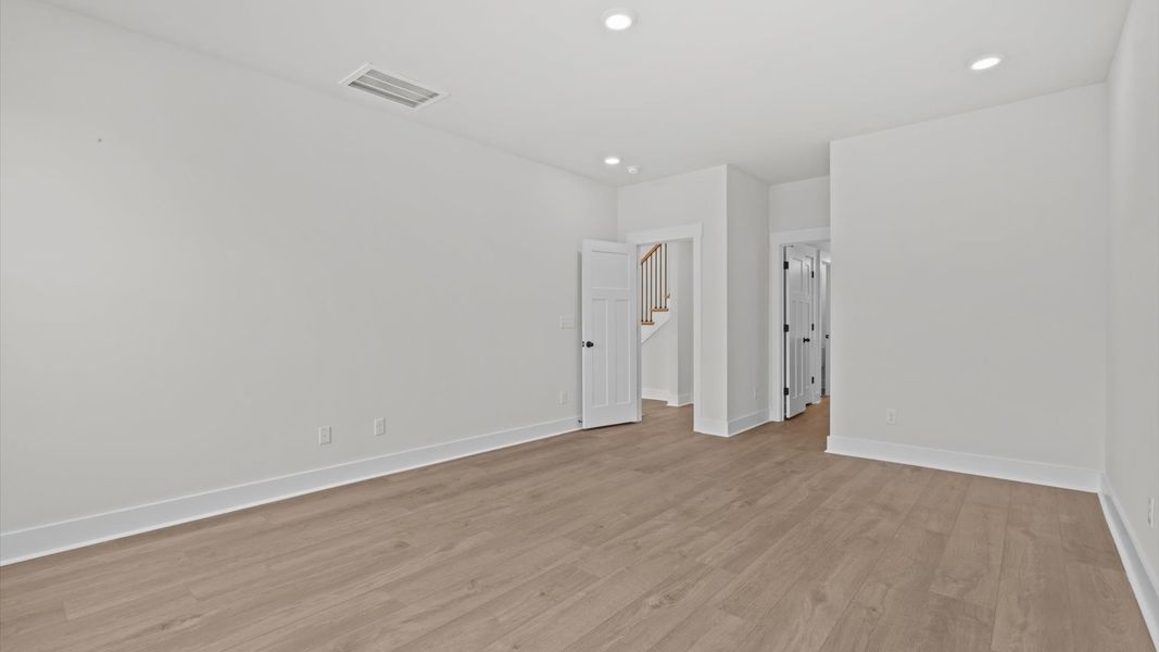 Accomplished primary retreat with eye-catching hardwood flooring in a desirable community