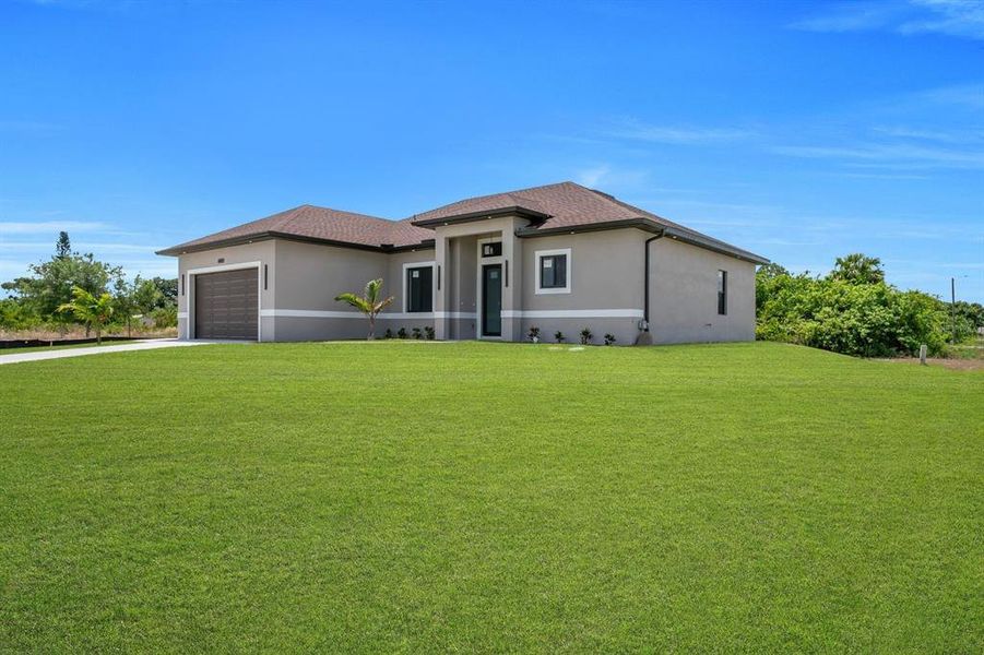Front exterior of a new home in , Lehigh Acres, FL, highlighting curb appeal (Image 25).