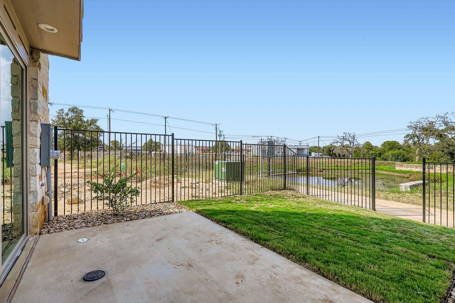 View of yard featuring a patio area and a water view