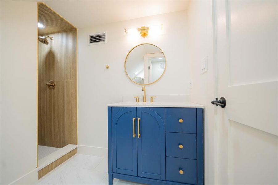 Full bathroom with walk in shower, vanity, and marble finish flooring Full bathroom with walk in shower, vanity, and marble finish flooring