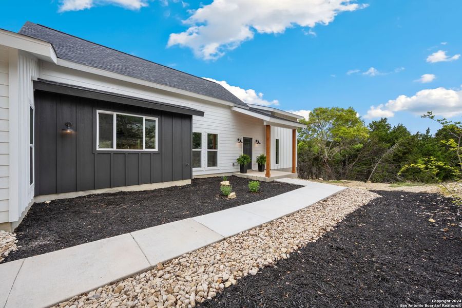 Front exterior of a new home in , Canyon Lake, TX, highlighting curb appeal (Image 26). Front exterior of a new home in , Canyon Lake, TX, highlighting curb appeal (Image 26).
