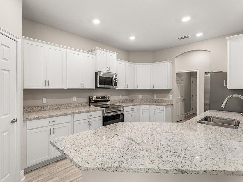 Your well-appointed kitchen includes granite, 36-inch cabinets, Samsung SS appliances, and a walk-in pantry.