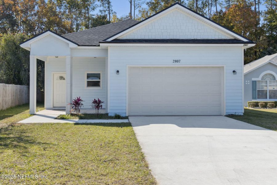 Front exterior of a new home in , Middleburg, FL, highlighting curb appeal (Image 1).