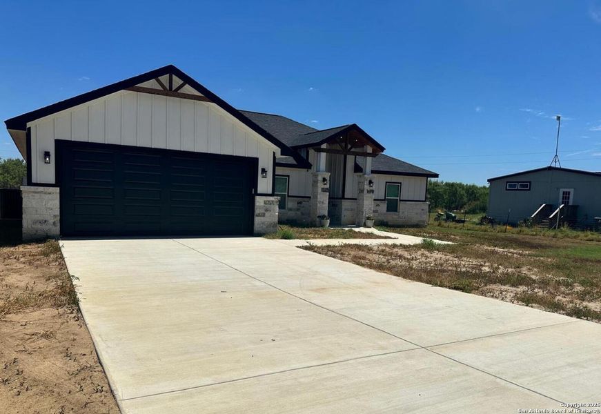 Front exterior of a new home in , Poteet, TX, highlighting curb appeal (Image 1). Front exterior of a new home in , Poteet, TX, highlighting curb appeal (Image 1).