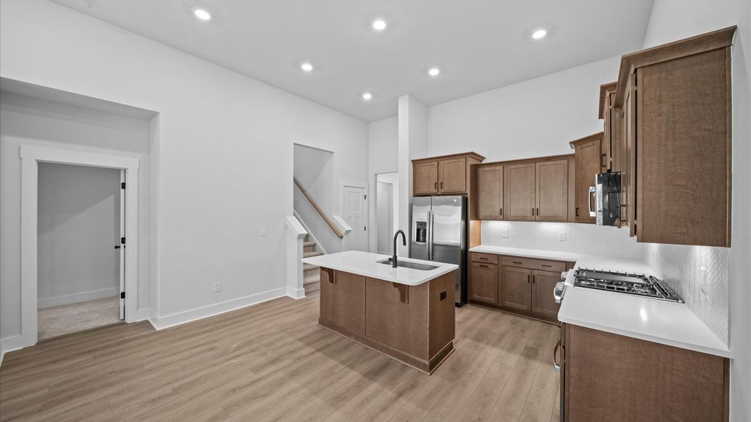 Vibrant kitchen layout with a center island, refined finishes, and open-concept flow