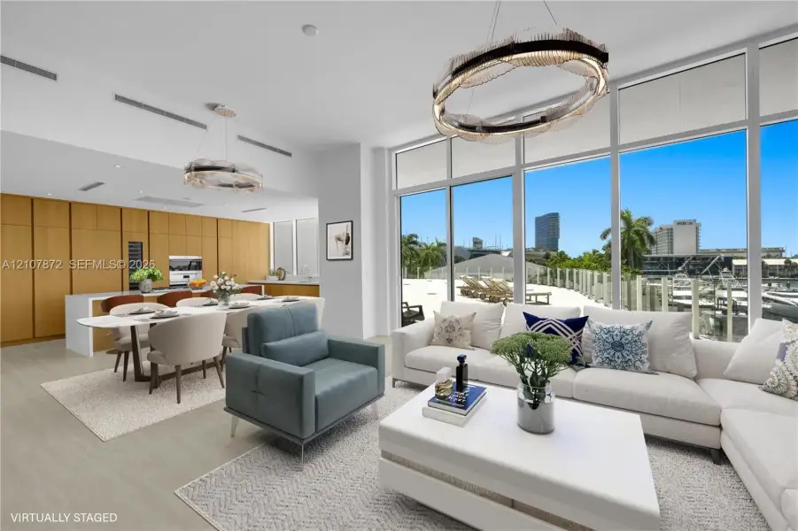 Floor-to-ceiling glass windows, floor-to-ceiling wood-finish cabinetry, built-in kitchen appliances, and geometric modern light fixtures Floor-to-ceiling glass windows, floor-to-ceiling wood-finish cabinetry, built-in kitchen appliances, and geometric modern light fixtures