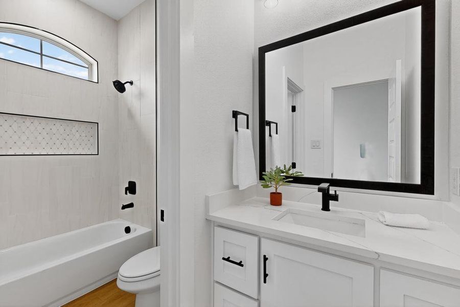 Bathroom with vanity, shower / tub combination, and wood finished floors