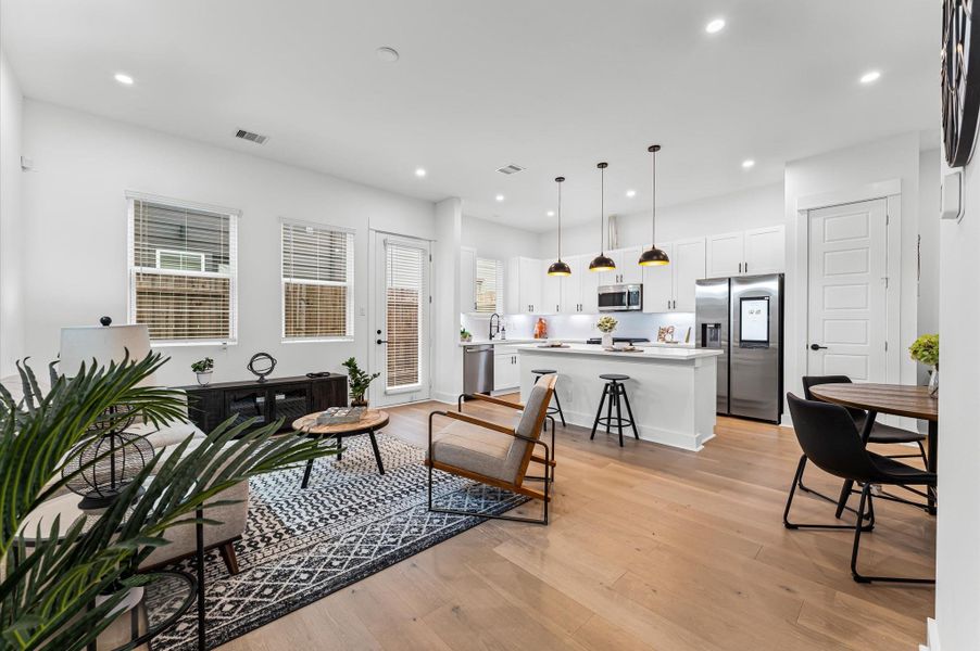 This inviting home features a spacious open-concept layout on the first floor, seamlessly connecting the living, dining, and kitchen areas to create a warm and functional gathering space. Large windows and glass door direct access to the backyard flooding the interior with natural light and extending the living space outdoors, perfect for entertaining or relaxing in the fresh air. The thoughtful design balances comfort and flow, making everyday living feel effortlessly connected to nature.