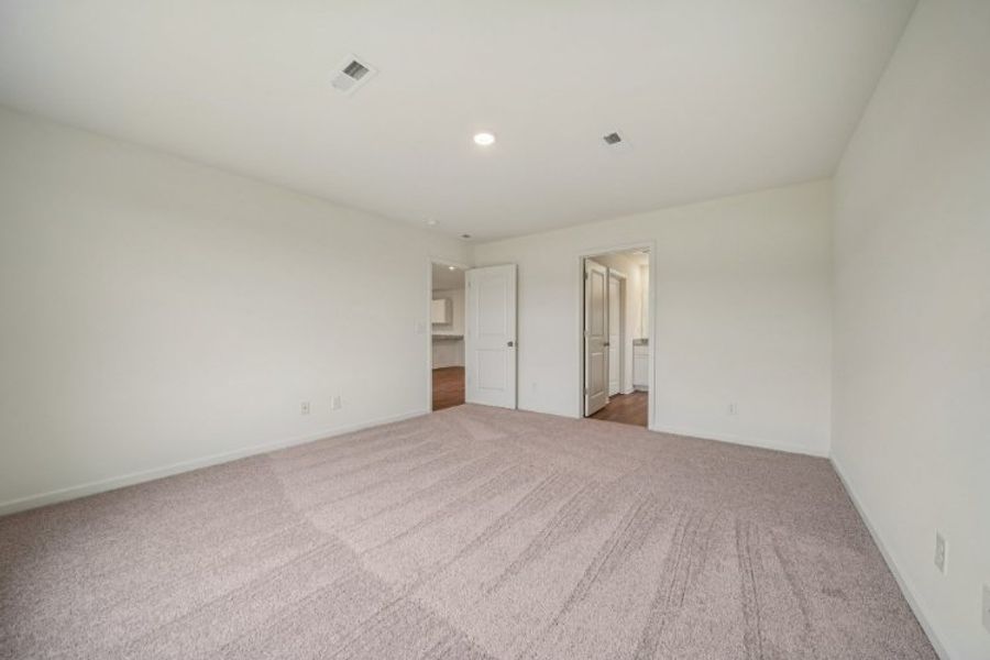 A room with a carpet and a door. A room with a carpet and a door.