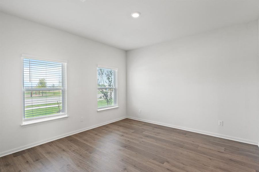 Dining room with dark wood-style flooring and plenty of natural light