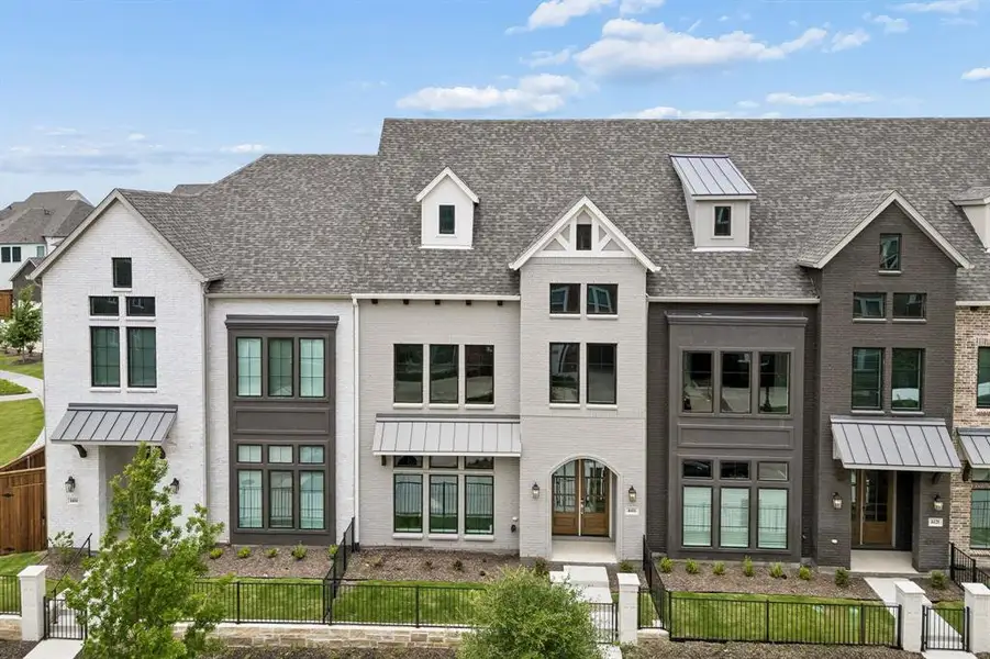 Front exterior of a new home in Newman Village Townhomes, Frisco, TX, highlighting curb appeal (Image 2). Front exterior of a new home in Newman Village Townhomes, Frisco, TX, highlighting curb appeal (Image 2).