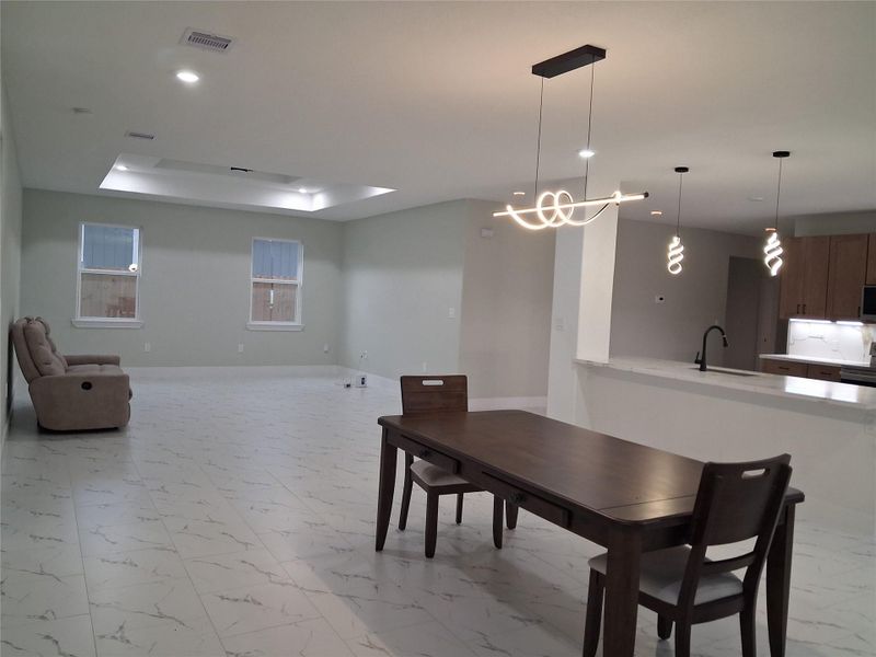 Open concept kitchen dining and living room.
