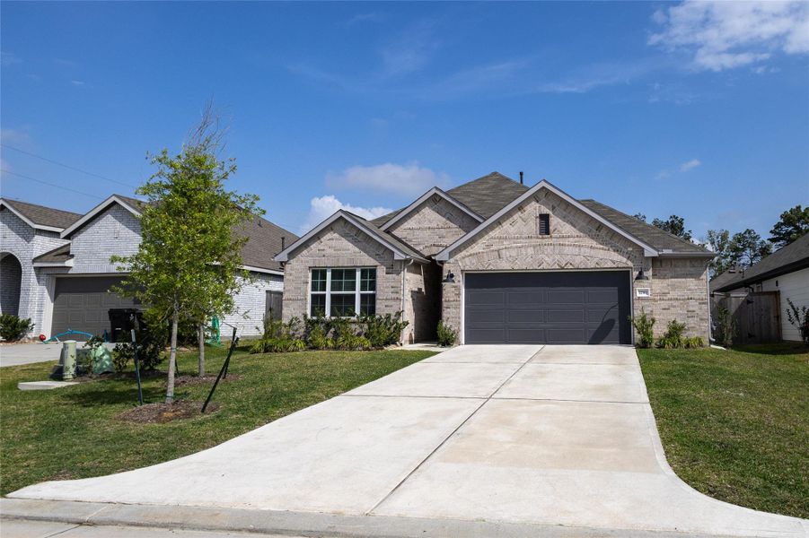 Front exterior of a new home in Pinewood at Grand Texas, New Caney, TX, highlighting curb appeal (Image 21).