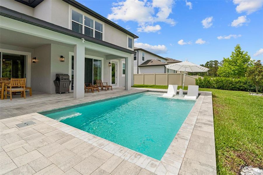 Exterior details and patio area of a home in Whispering Oaks Preserve, Wesley Chapel (Image 26).