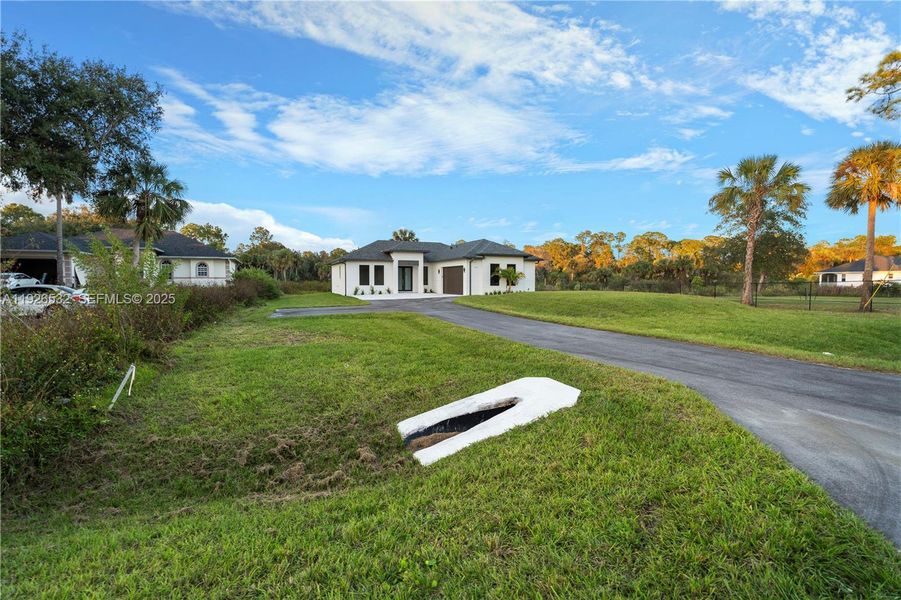 Front exterior of a new home in , Naples, FL, highlighting curb appeal (Image 27). Front exterior of a new home in , Naples, FL, highlighting curb appeal (Image 27).