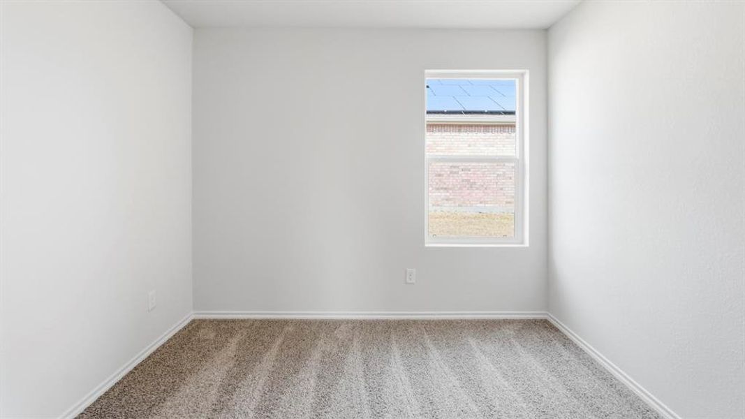 Spare room featuring light colored carpet and baseboards Spare room featuring light colored carpet and baseboards
