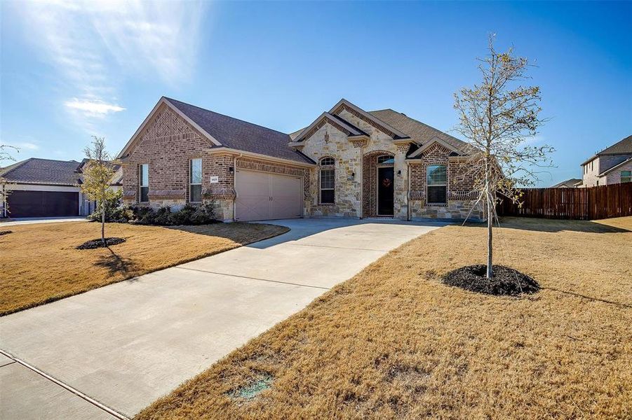 View of front of home with a front yard and a garage