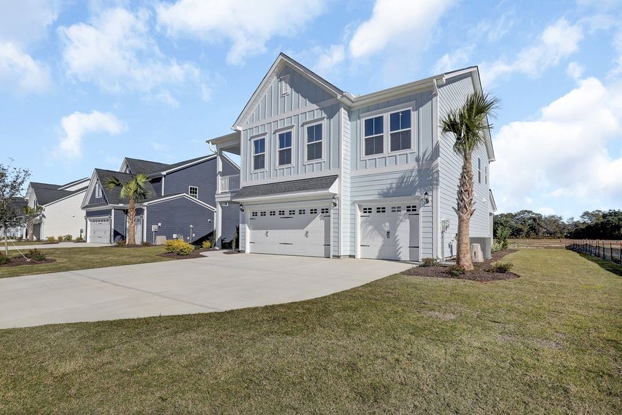 Front exterior of a new home in East Wynd, Hampstead, NC, highlighting curb appeal (Image 2).