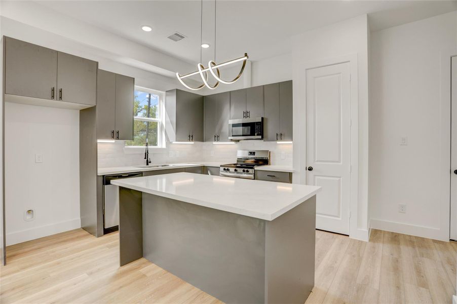 The 10x15 SF kitchen has 3cm quartz counters and top-of-the-line Frigidaire stainless steel appliances.