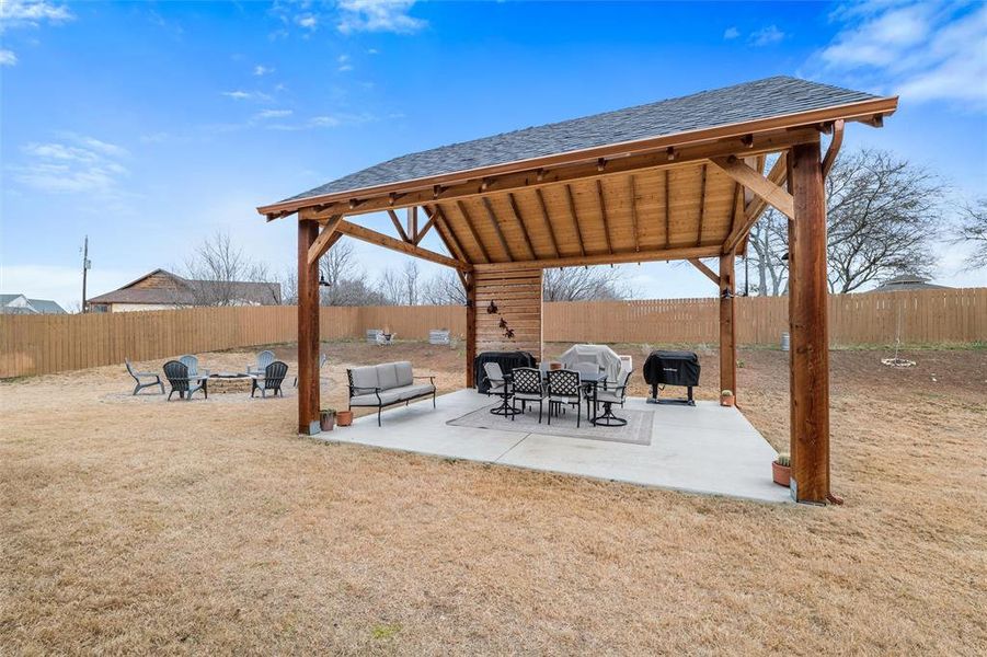 View of patio with a gazebo and an outdoor fire pit