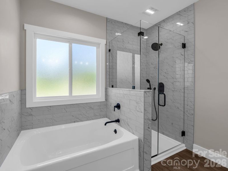 Primary bath offers a beautiful tiled shower and spa like soaking tub. The windows have privacy glass. Primary bath offers a beautiful tiled shower and spa like soaking tub. The windows have privacy glass.