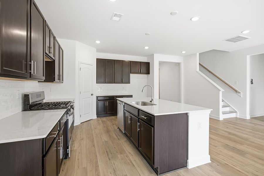 A kitchen with black cabinets. A kitchen with black cabinets.