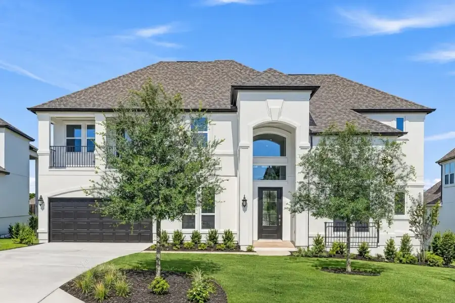 Front exterior of a new home in Travisso, Leander, TX, highlighting curb appeal (Image 16). Front exterior of a new home in Travisso, Leander, TX, highlighting curb appeal (Image 16).