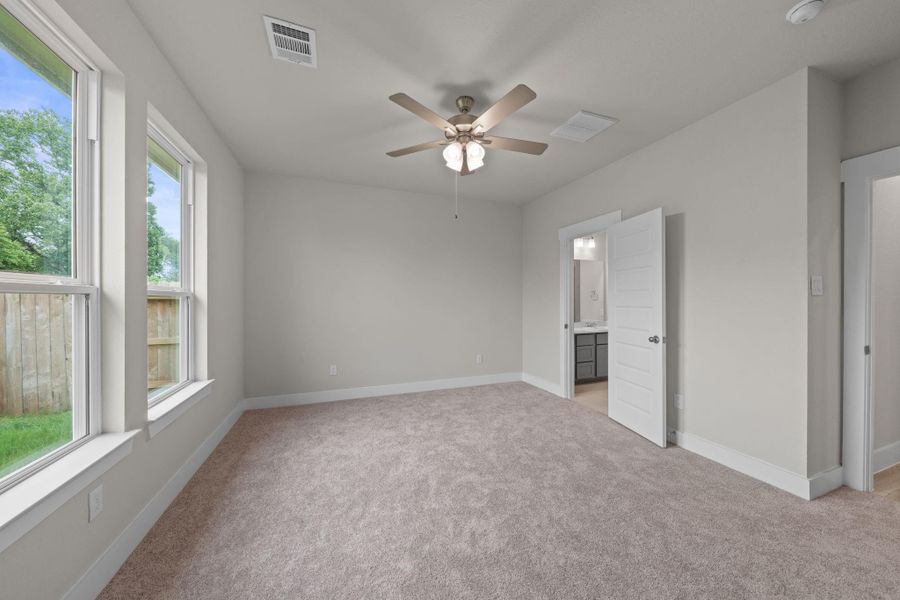 A modern ceiling fan with a built-in light fixture enhances both airflow and ambiance, creating an ideal retreat at the end of the day.