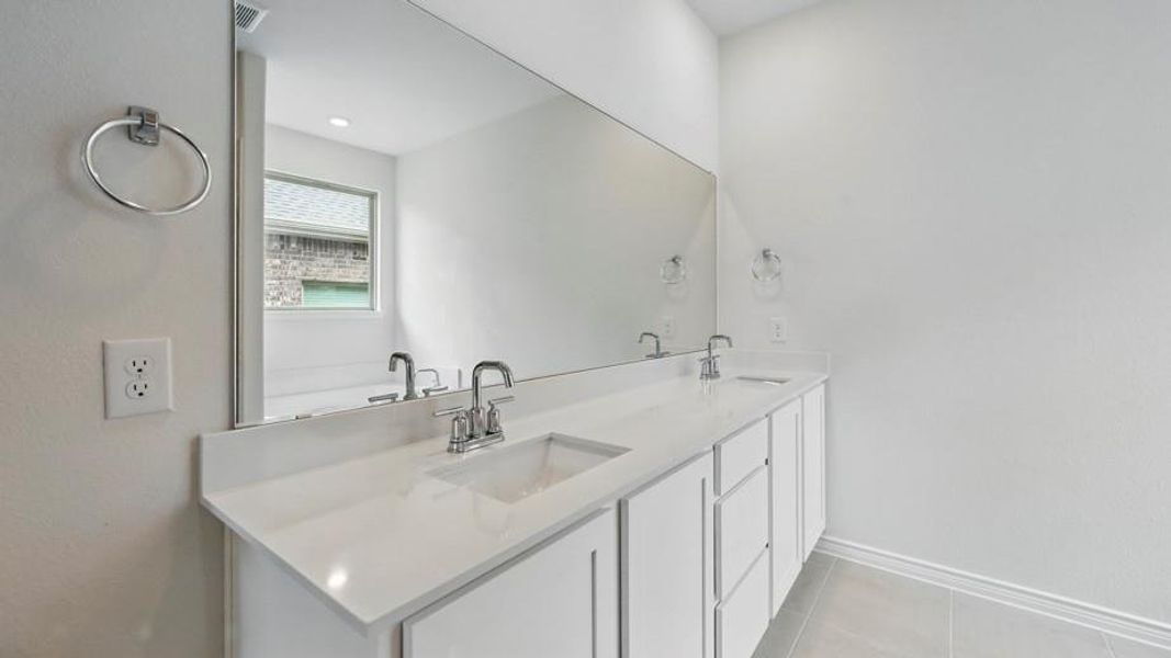 Dual vanity with integrated sinks and chrome fixtures