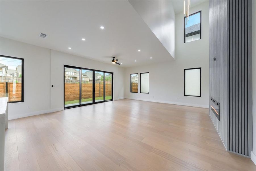 Family room with recessed lighting, light wood-style flooring, and a ceiling fan