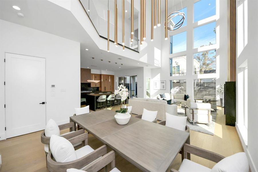 Open-concept dining area flows seamlessly into the living room, offering abundant Natural light through expansive windows