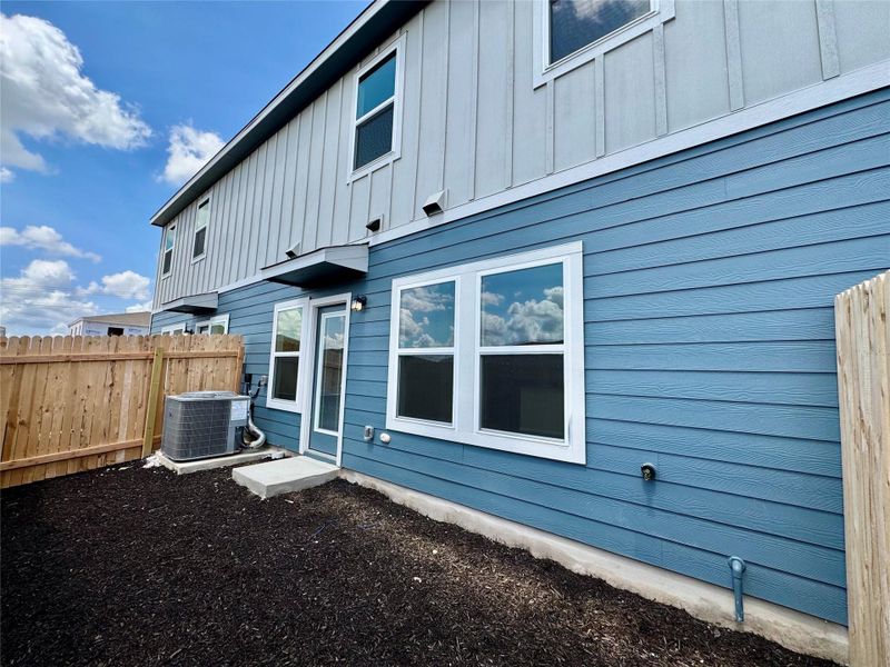 Back of house featuring board and batten siding Back of house featuring board and batten siding