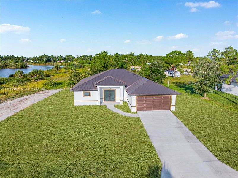 Front exterior of a new home in , Lehigh Acres, FL, highlighting curb appeal (Image 23).