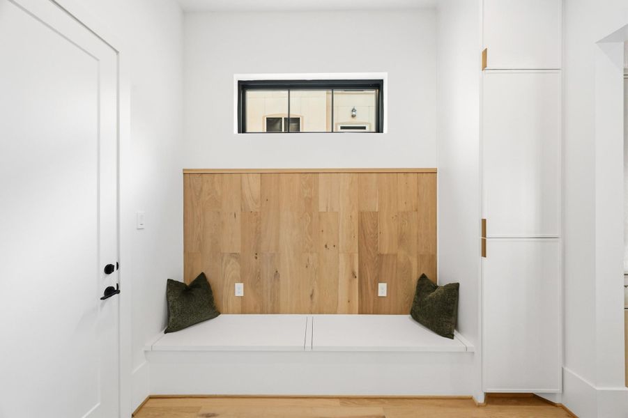 Just in from the garage is the beautiful mudroom with bin and cabinet storage!
