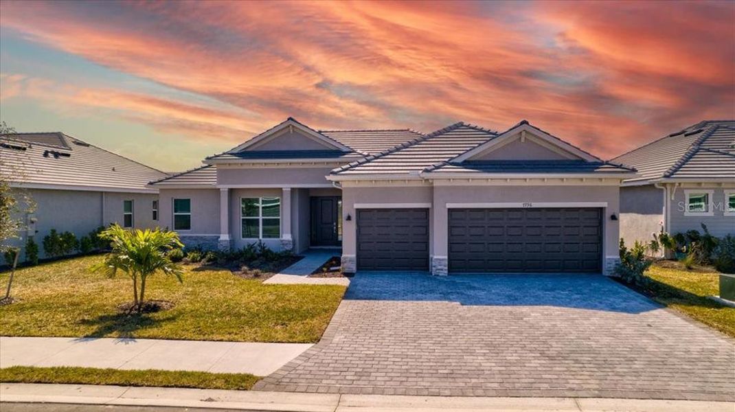 Front exterior of a new home in Harbor East, Port Charlotte, FL, highlighting curb appeal (Image 18).