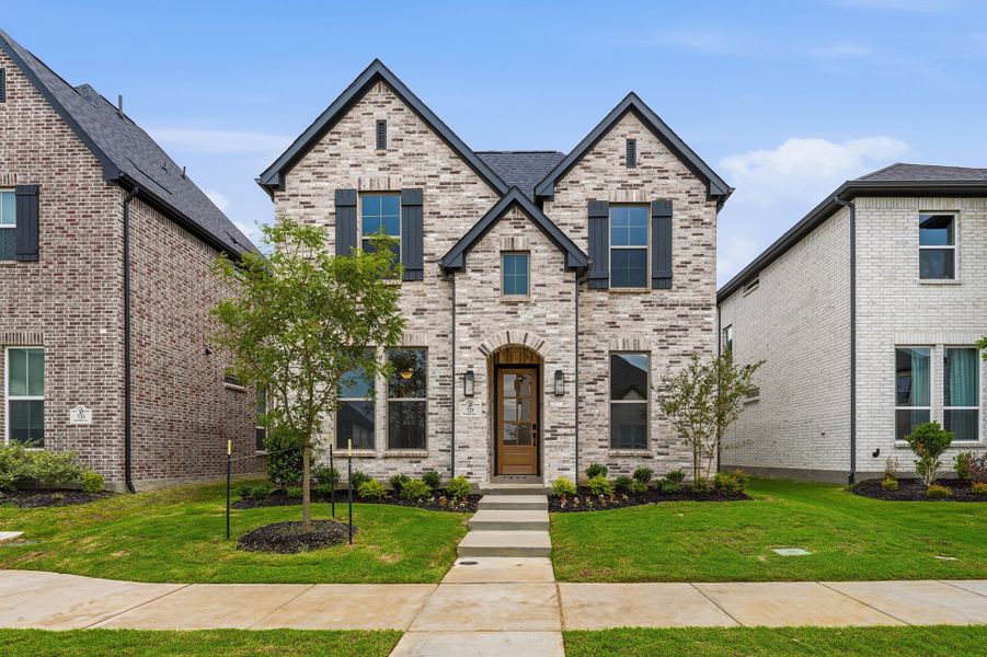 Front exterior of a new home in Light Farms Brenham - 40' Lots, Celina, TX, highlighting curb appeal (Image 1). Front exterior of a new home in Light Farms Brenham - 40' Lots, Celina, TX, highlighting curb appeal (Image 1).