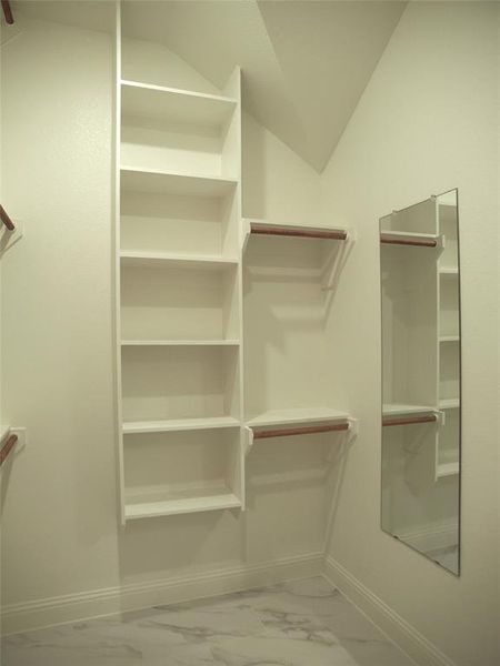 Walk in closet featuring lofted ceiling