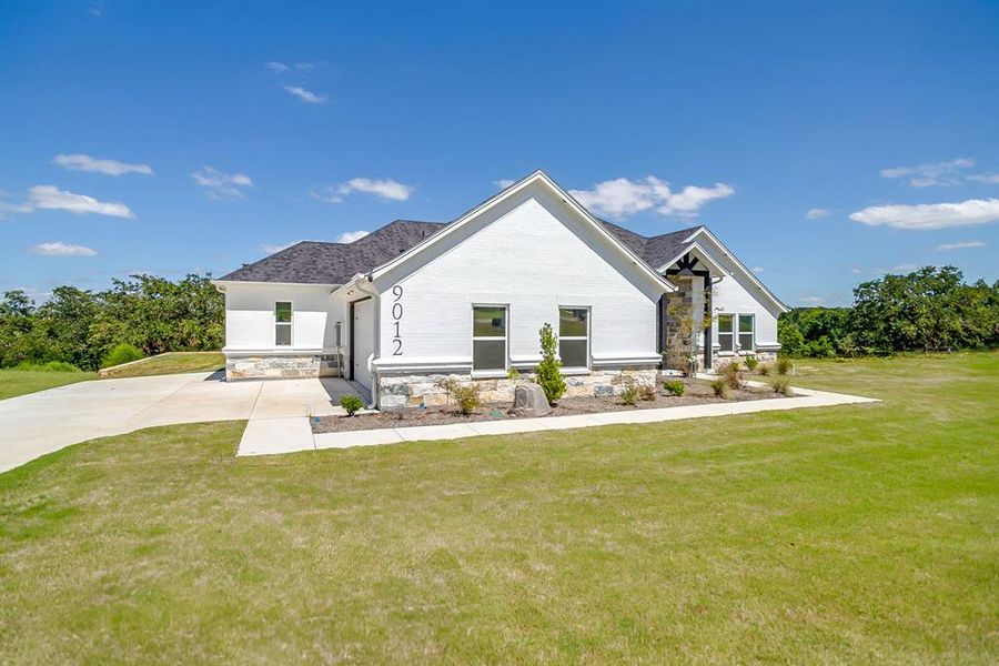 Front exterior of a new home in , Springtown, TX, highlighting curb appeal (Image 1). Front exterior of a new home in , Springtown, TX, highlighting curb appeal (Image 1).